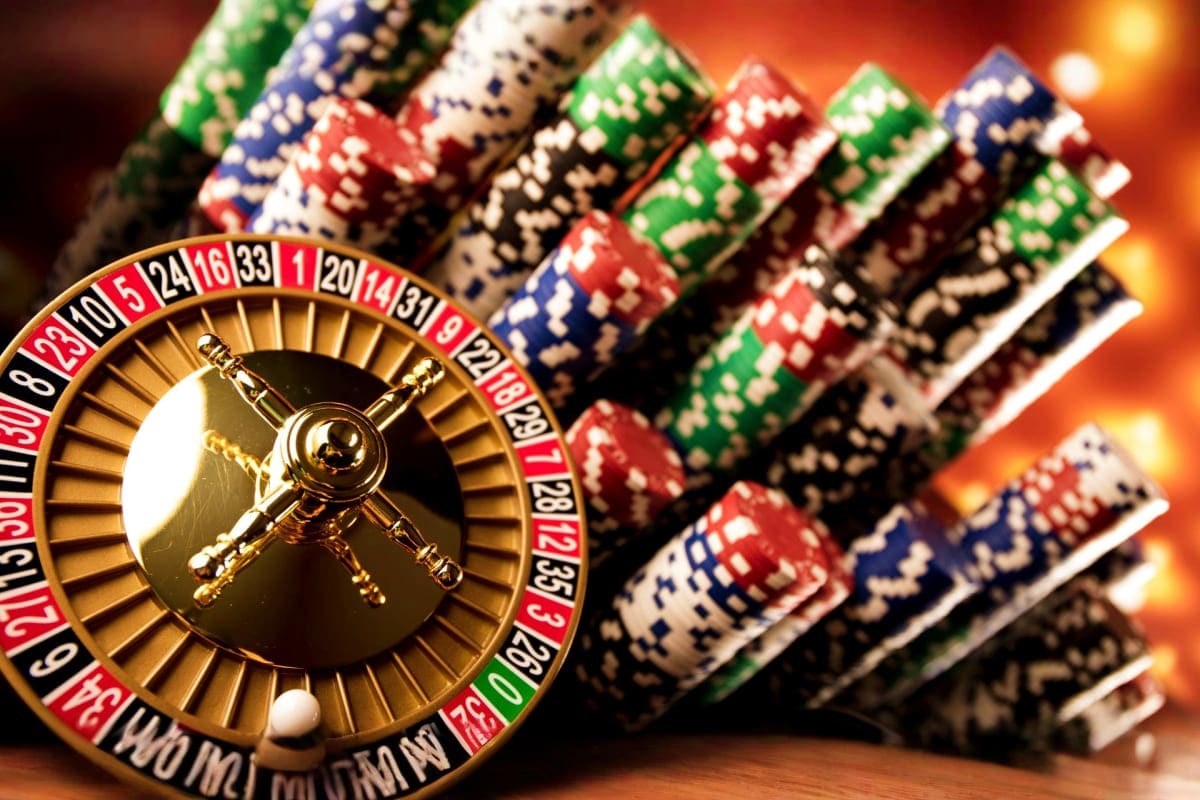 Genting Highlands Tour with Awana Cable Car and Batu Caves Visit Roulette wheel with stacked casino chips and warm golden lighting in background