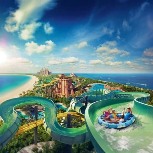 Aerial view of Atlantis Aquaventure Waterpark with colorful water slides, lazy river, resort buildings, and turquoise Arabian
