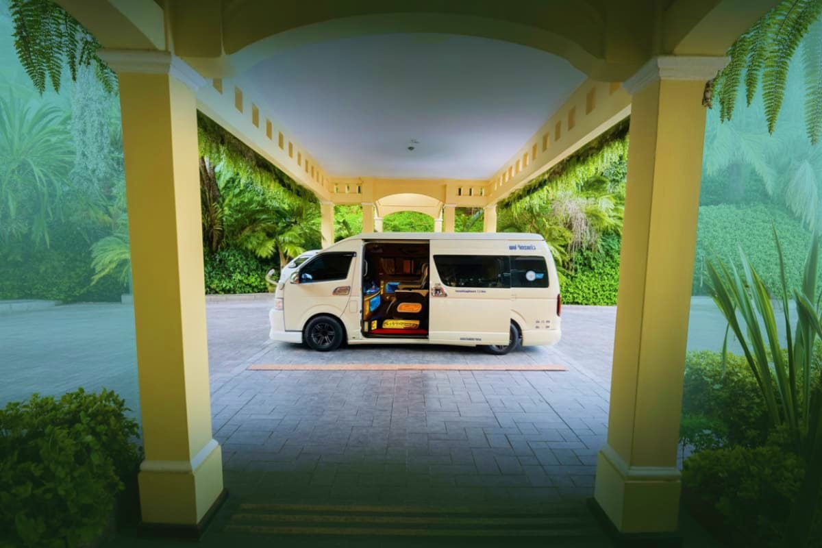 Donmueang International Airport Pickup White luxury van with open sliding door parked in modern covered garage with green living walls and tropical plants