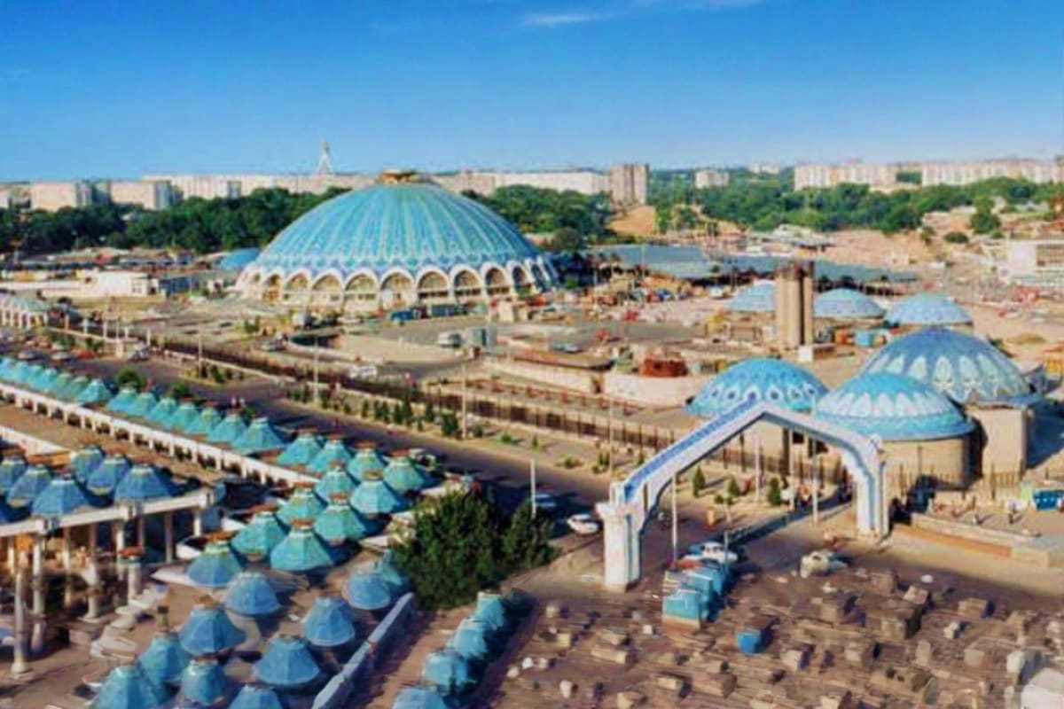 Tashkent City Tour Aerial view of Tashkent cityscape featuring distinctive blue domed buildings and modern architecture against clear sky