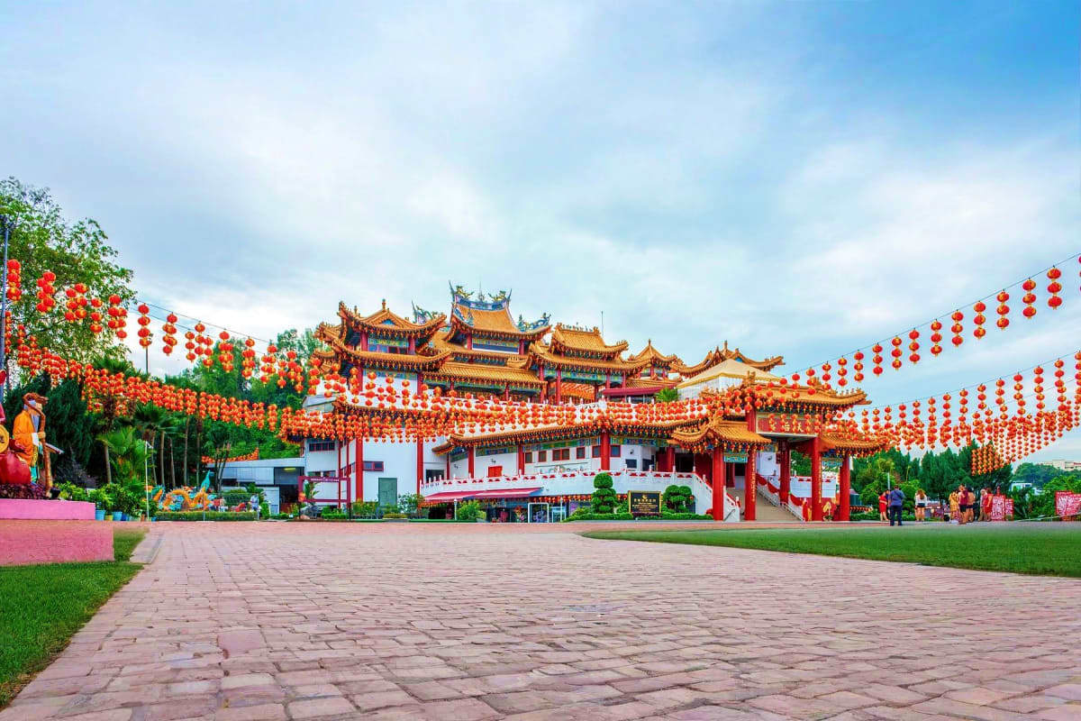 The Great Kuala Lumpur Iconic Attractions Tour Traditional Chinese temple with golden-tiered roofs decorated with red lanterns and white walls in Kuala Lumpur