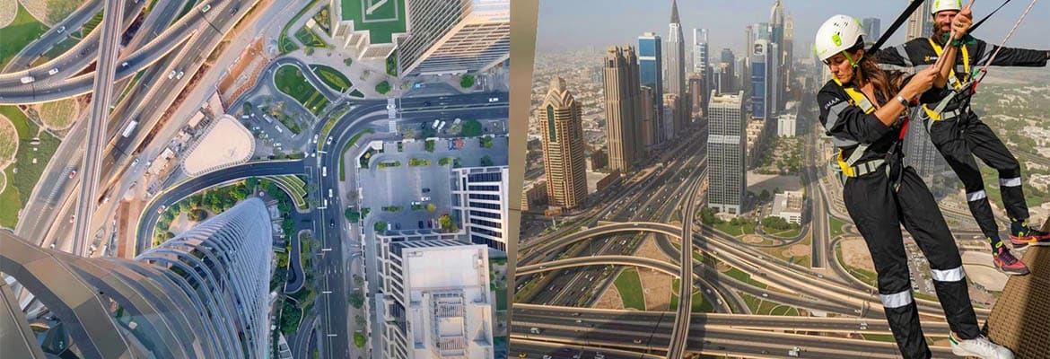 Sky Views Edge Walk Workers performing rope access maintenance on tall Dubai building with cityscape and elevated highways visible below