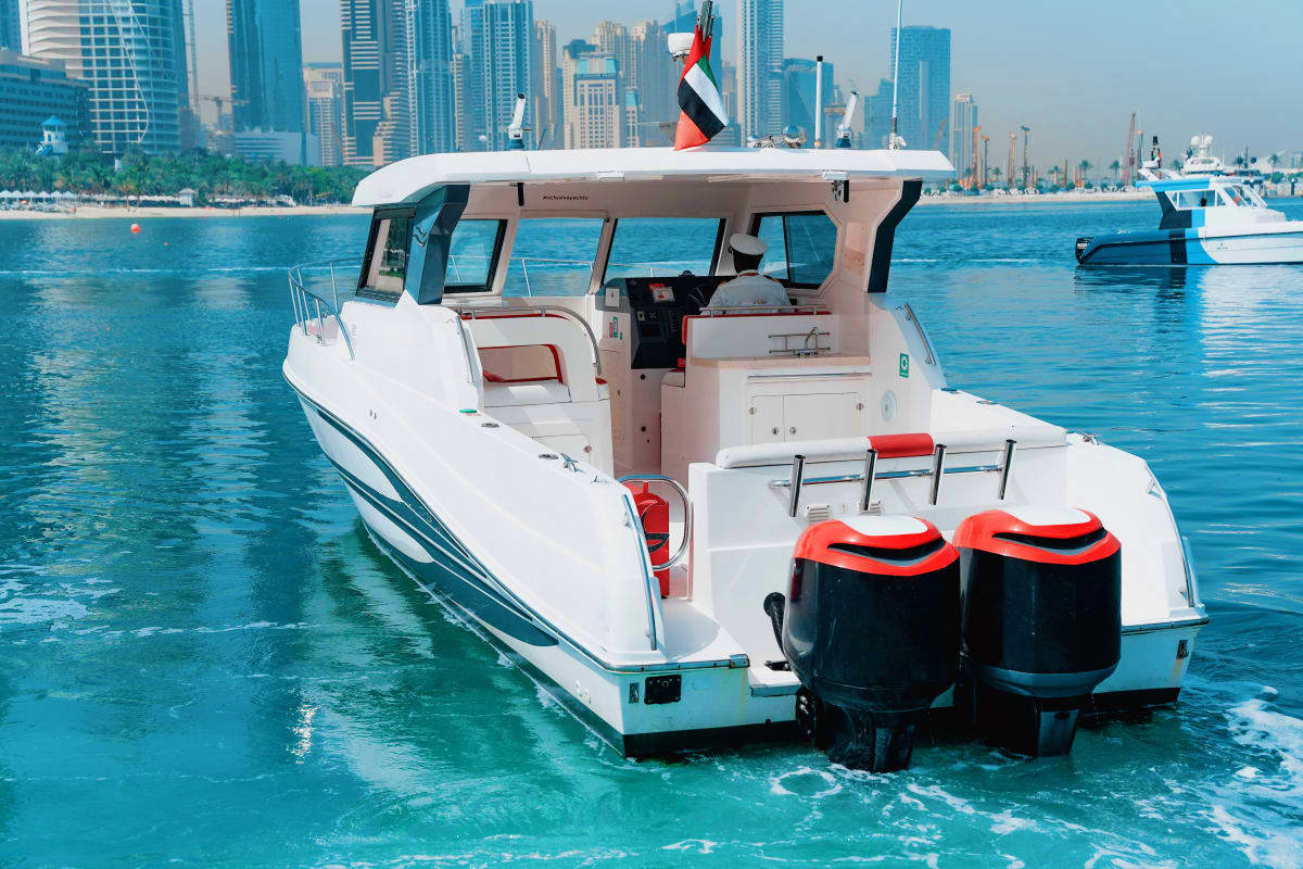 Silver Craft X13 Silver Craft X13 yacht moored in turquoise water with Dubai skyline and palm trees in background