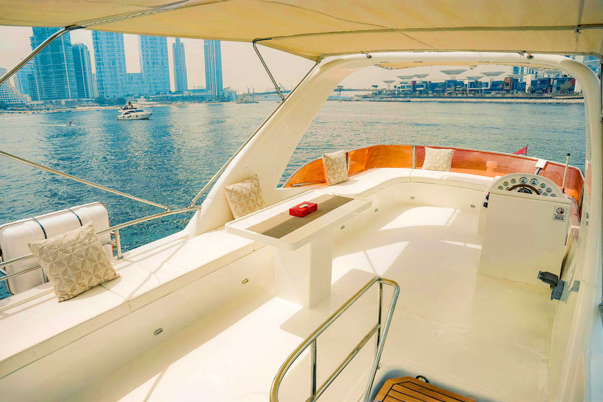 Duretti X1 Duretti X1 yacht deck with steering wheel, cream seating, and tan canopy overlooking downtown Miami skyline and waterfront