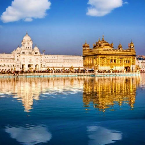 Golden Temple and Gurudwara Bangla Sahib reflecting in the sacred pool at Amritsar, Punjab, India