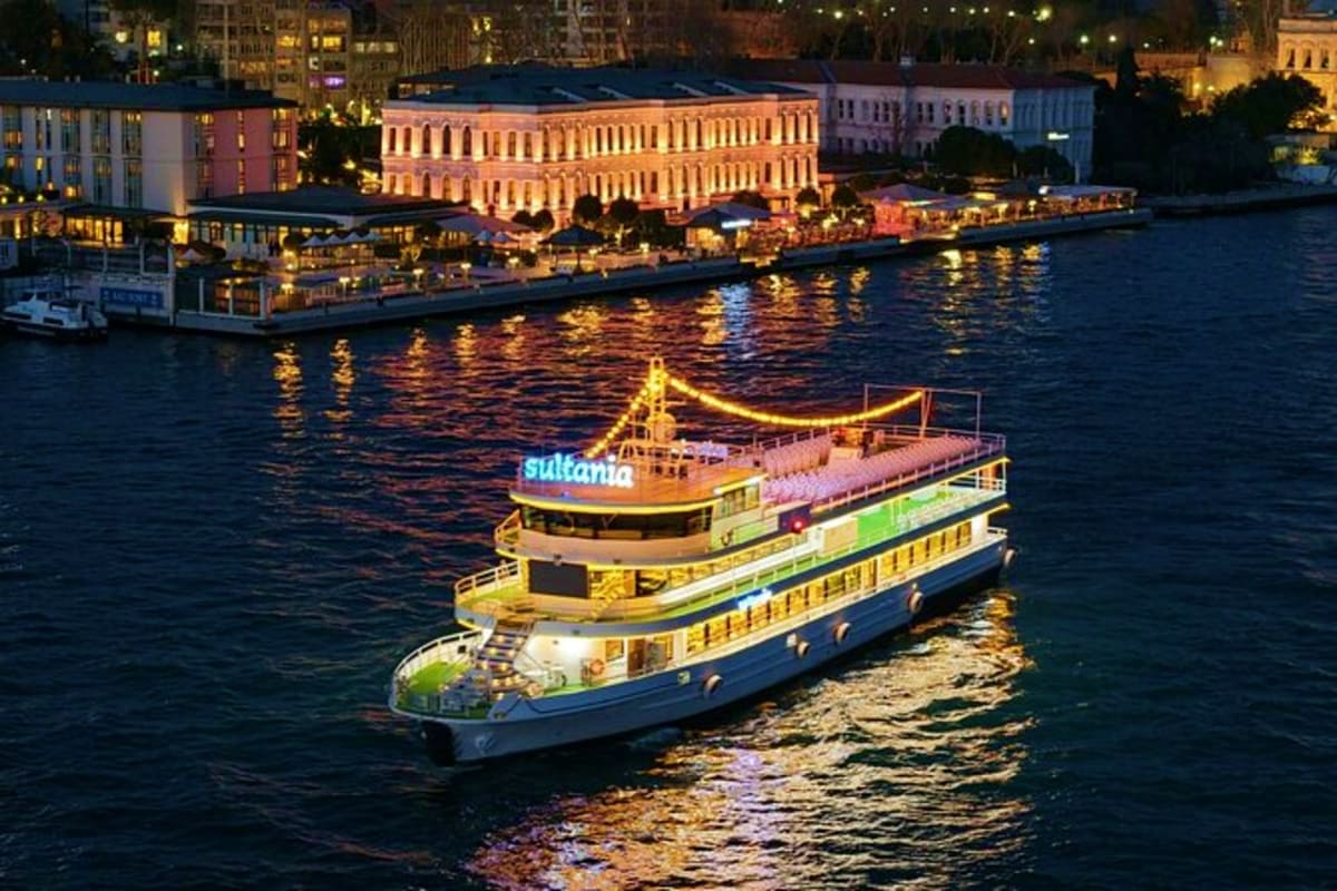 Sultania cruise ship illuminated at night on the Golden Horn in Istanbul with historic waterfront buildings in background