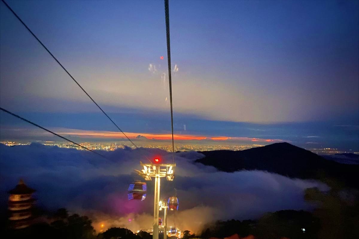 Best of Kuala lumpur and Langkawi Kuala Lumpur skyline at dusk with illuminated Petronas Towers visible through mist and low clouds, taken from elevated vantag