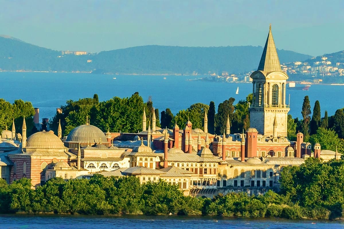 Topkapi Palace overlooking the Golden Horn in Istanbul, Turkey, with minarets and domes visible across the waterfront