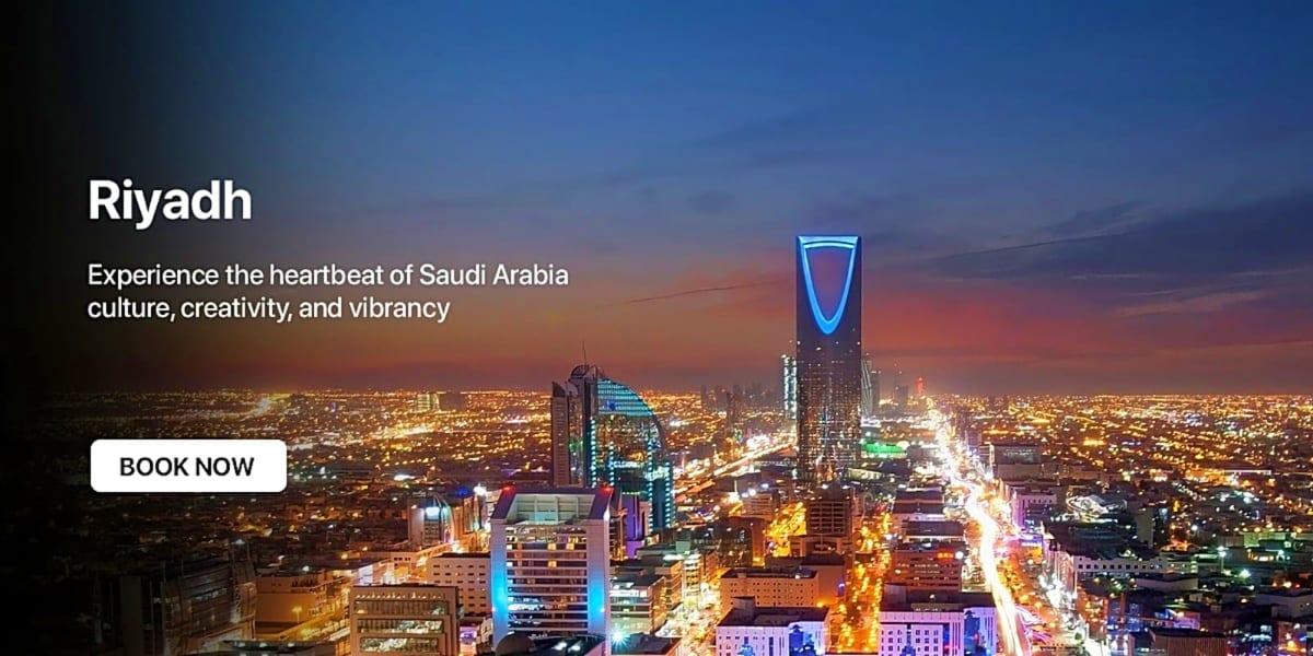 Riyadh skyline at night with illuminated skyscrapers and Kingdom Centre tower against twilight sky