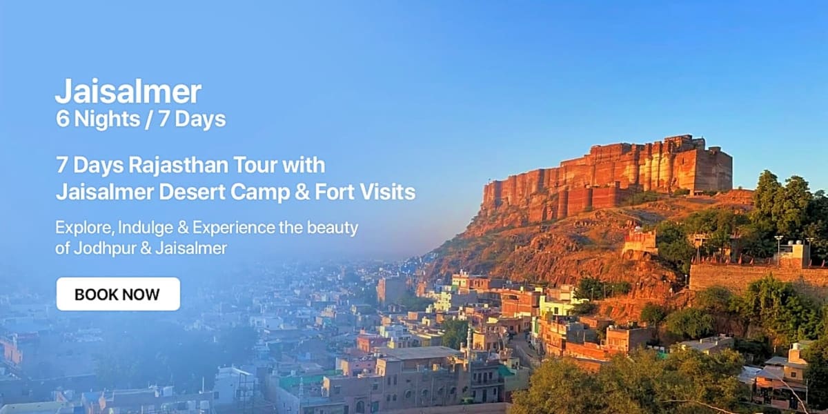 Mehrangarh Fort perched on a hilltop overlooking the blue city of Jodhpur at sunrise with desert landscape