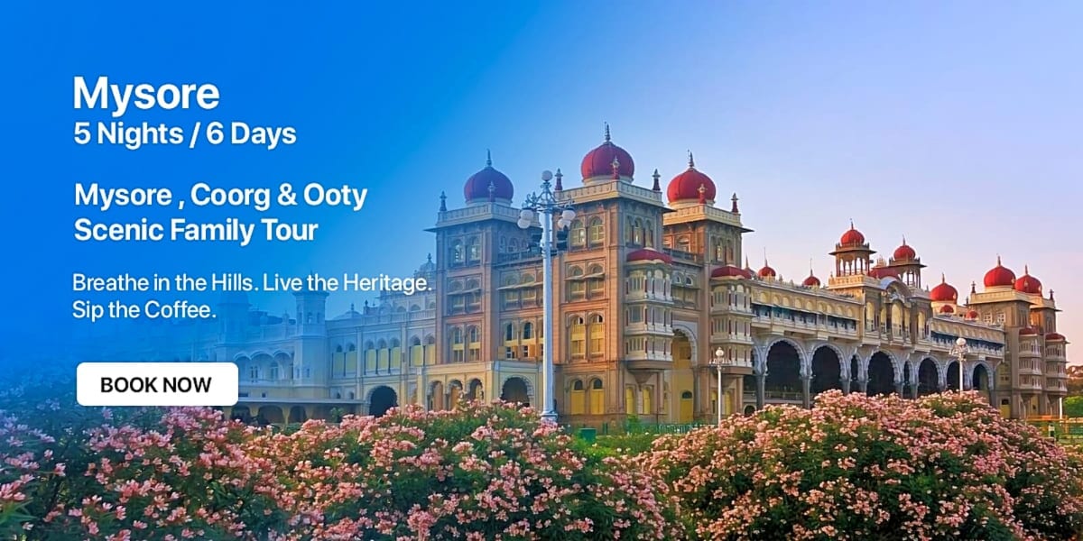 Palace with red domes surrounded by pink flowers in Mysore, India