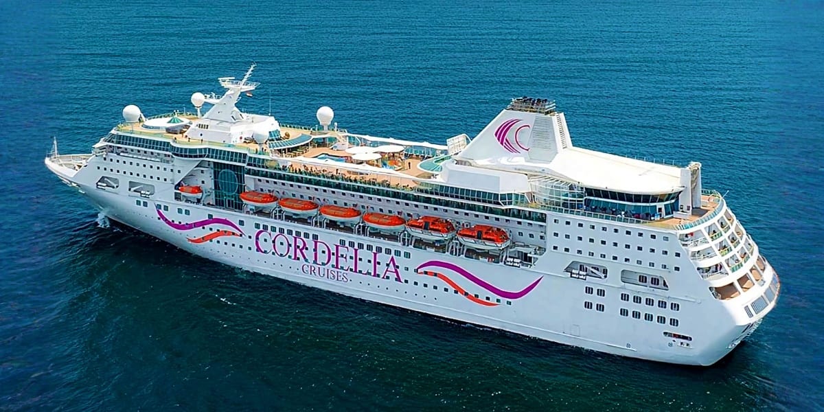 Cordelia cruise ship on turquoise ocean water with lifeboats visible on deck