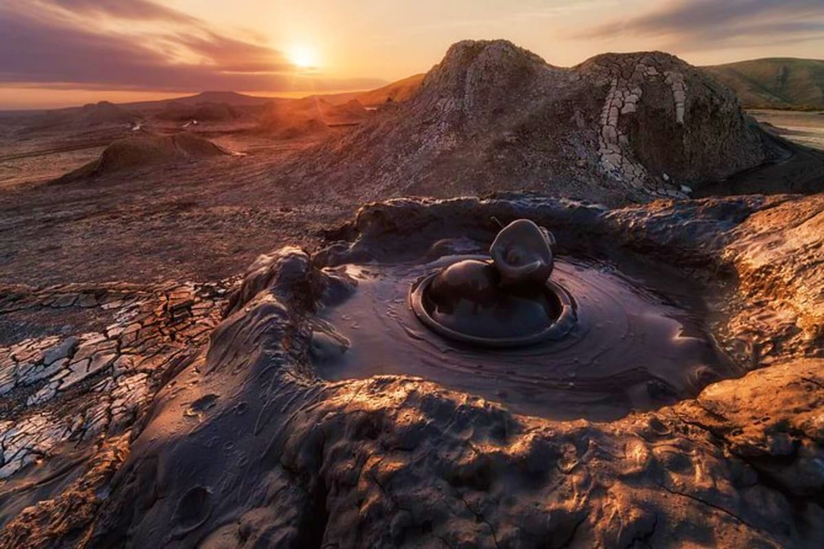 Mud volcano with bubbling crater at sunset in Absheron National Park near Baku, Azerbaijan