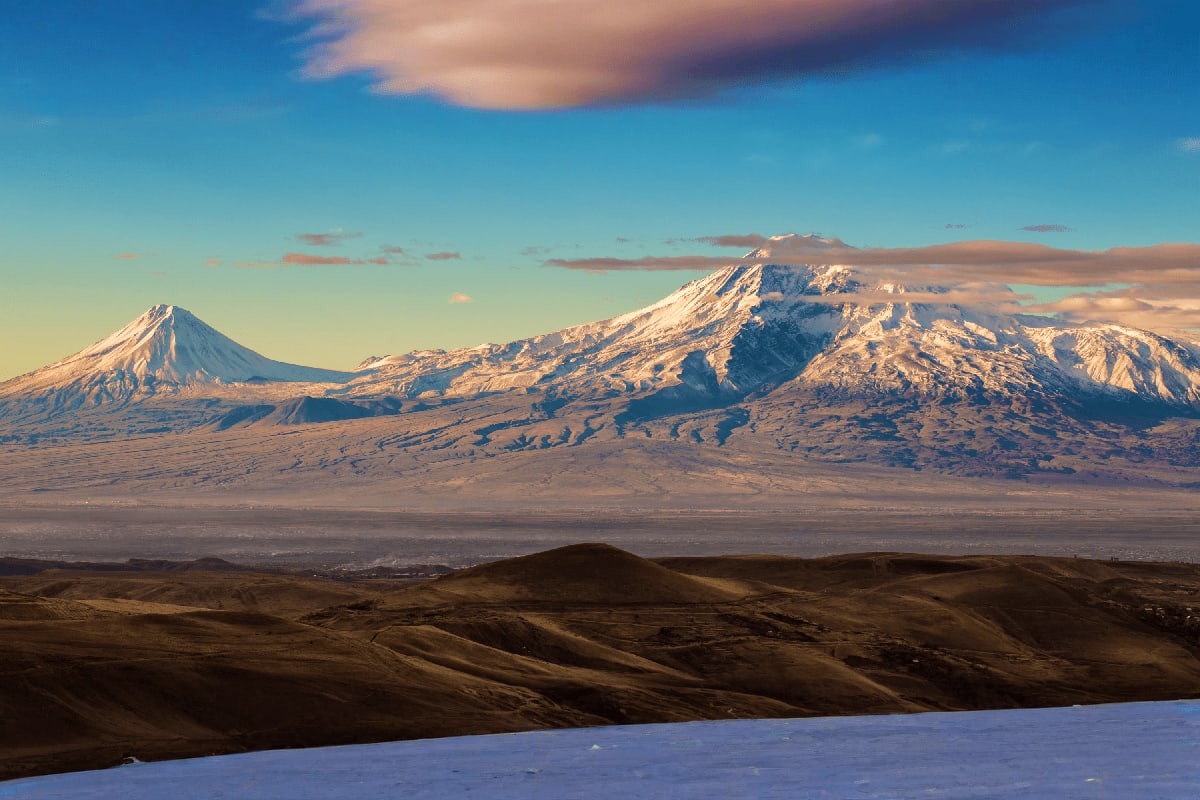 Mt Ararat Wine Tasting & Dinner at Tushpa Winery Snow-capped Mount Ararat peaks with volcanic terrain and blue sky, view from Tushpa Winery in Armenia