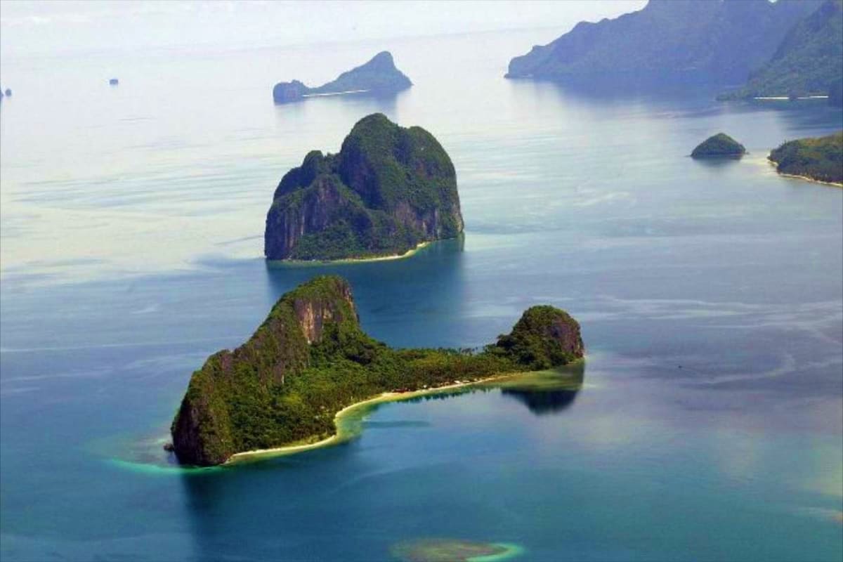 Aerial view of limestone islands with white sand beaches and turquoise waters in El Nido, Palawan, Philippines