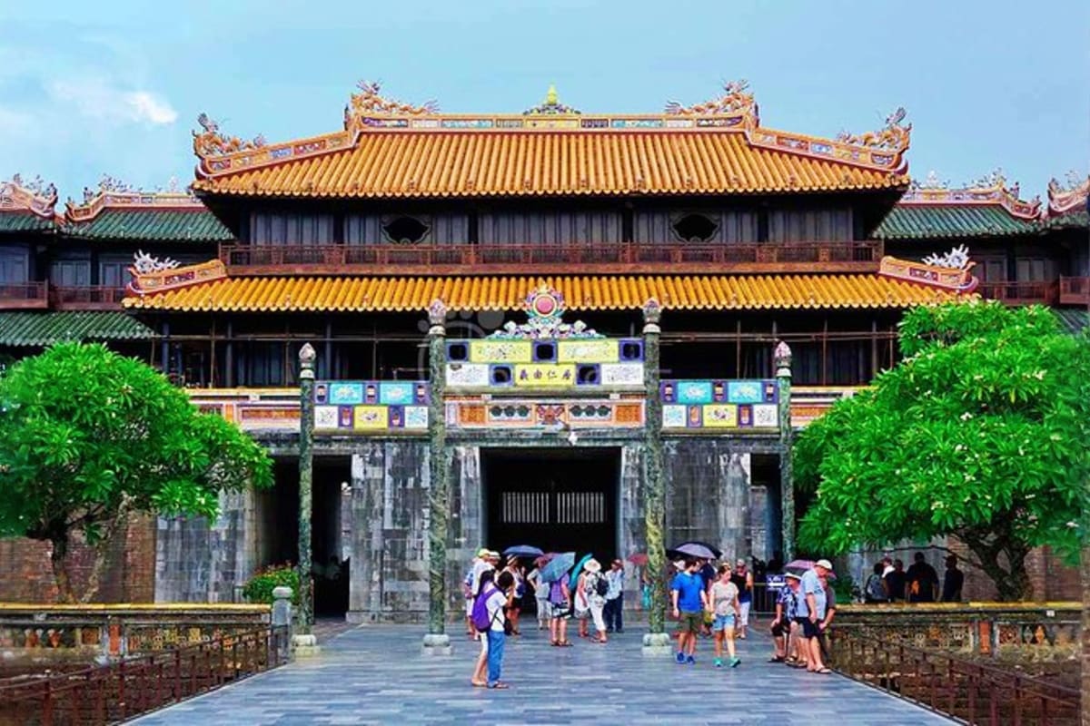 Hue City tour Tourists at the entrance of the Citadel in Hue, Vietnam, a historic imperial fortress with yellow-tiled roofs and ornate drag