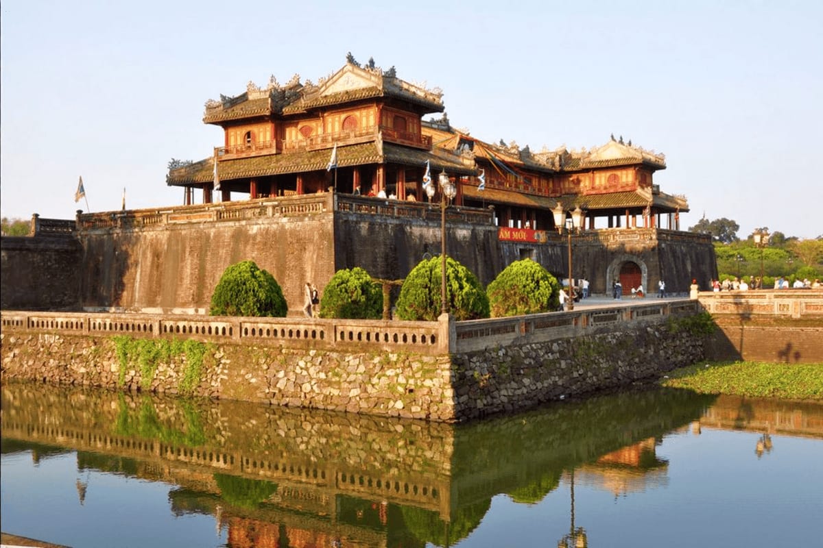 Hue City tour Citadel of Hue with traditional Vietnamese architecture, moat, and ornamental gardens reflecting in water