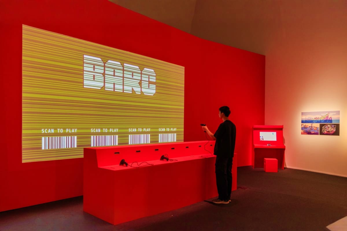 ArtScience Museum Singapore Interactive BARO exhibition display at ArtScience Museum Singapore with red walls, digital screens, and visitor scanning QR c