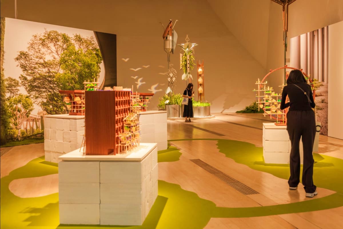 ArtScience Museum Singapore Modern art exhibition space at ArtScience Museum Singapore with architectural models, green flooring, and visitors exploring