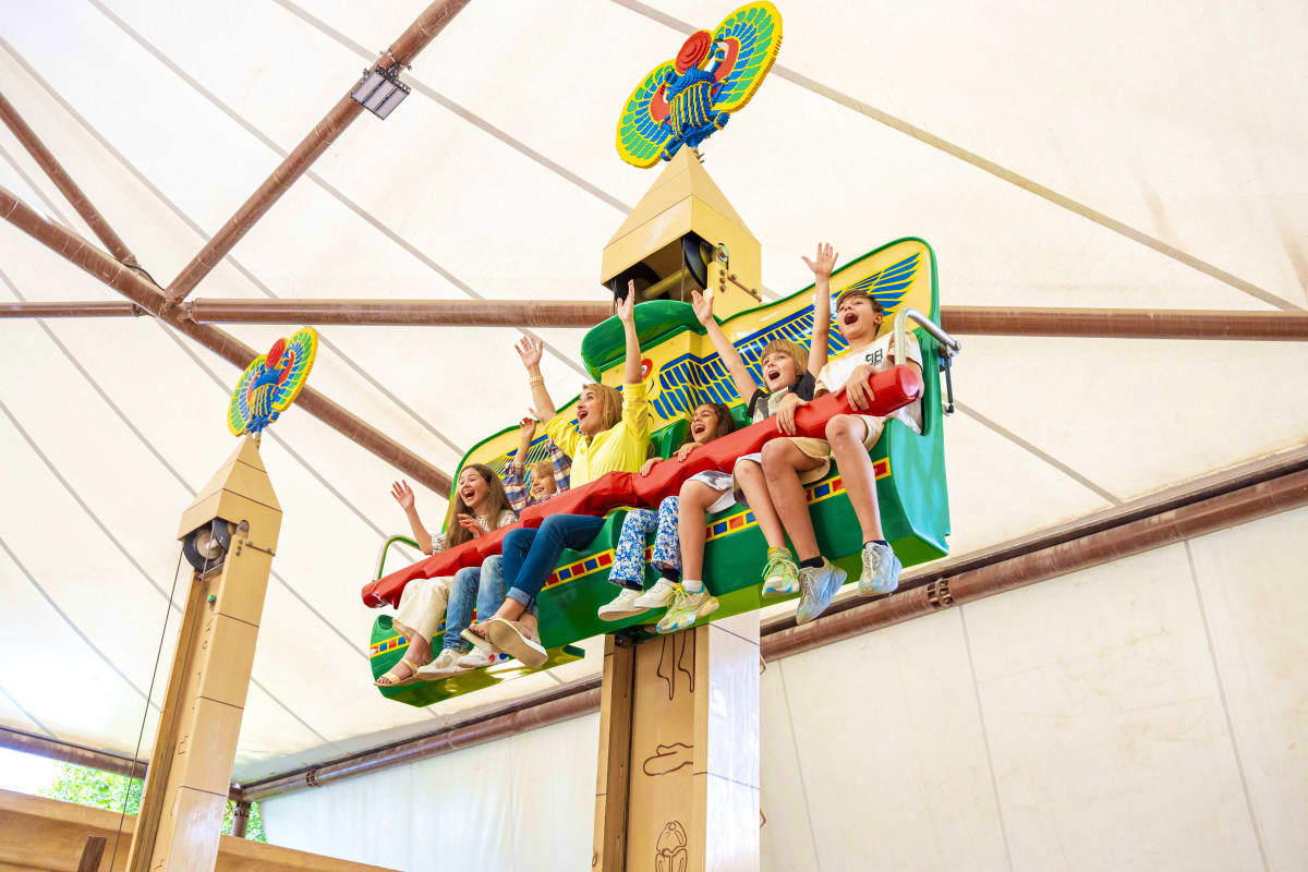 Dubai Parks and Resorts Children riding an Icarus-themed roller coaster at Dubai Parks and Resorts amusement park