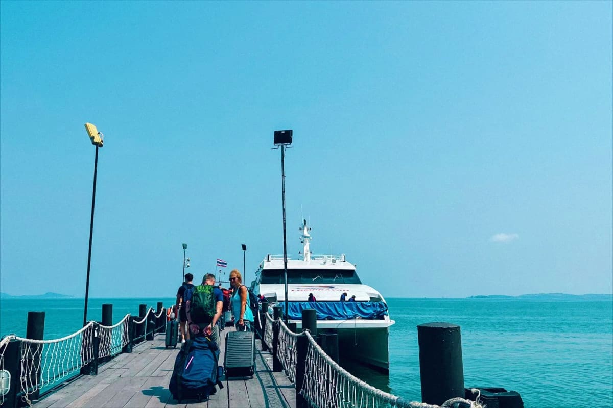 Ferry Tickets for Koh Samui Pier to Koh Tao Maehaad Passengers boarding a white ferry at a wooden pier with turquoise waters and clear blue sky at Koh Samui Pier