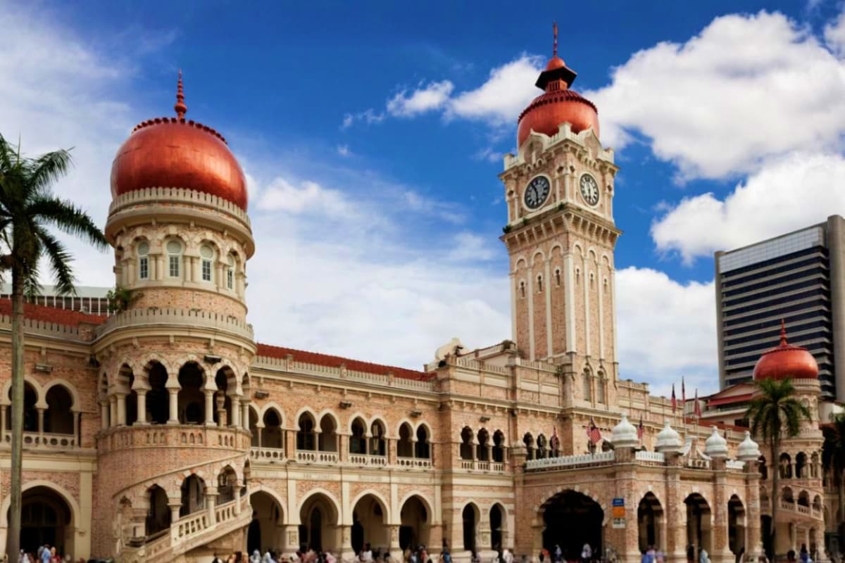 Kuala Lumpur City Tour with Twin Towers Historic Sultan Abdul Samad Building with red dome and clock tower in Kuala Lumpur city center under blue sky