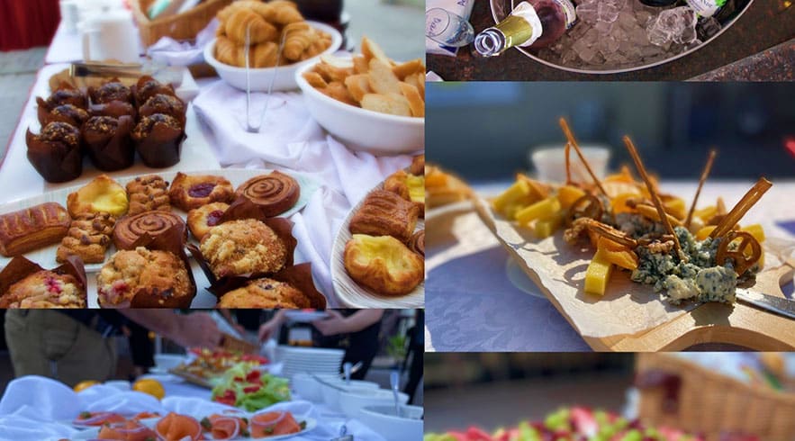 Assorted pastries, breads, and grilled skewered meats served on white plates during a hot air balloon breakfast experience in