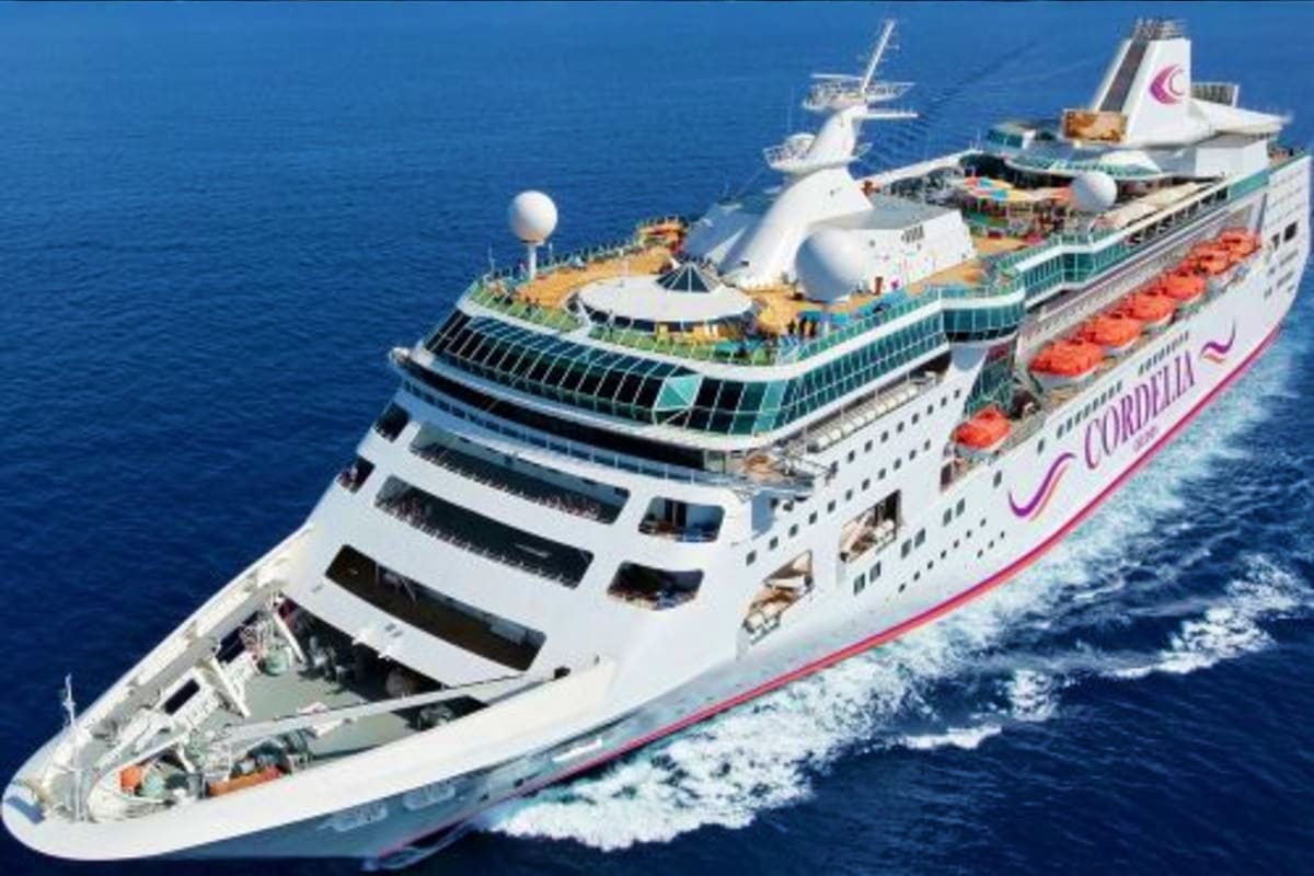 Cordelia cruise ship sailing on blue ocean water with multiple decks, lifeboats, and funnel visible from aerial view