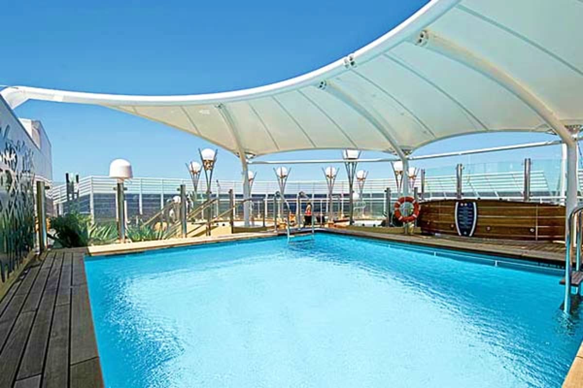 Rooftop swimming pool with white retractable shade on MSC Preziosa cruise ship under clear blue sky