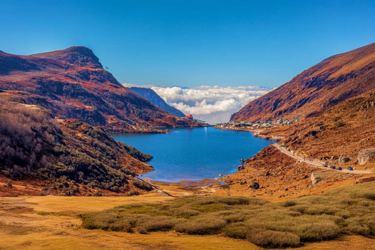 Sikkim and Darjeeling Scenic Circuit Tour with Pelling Skywalk High altitude mountain lake surrounded by brown rocky peaks with sparse vegetation under clear blue sky, Sikkim Himalayas lan