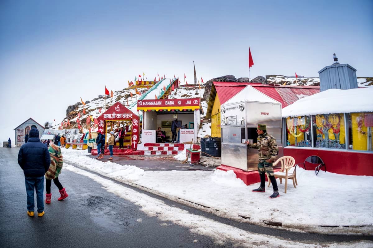 Ayyappan temple fair at Gurudongmar Lake in Sikkim with snow, devotees, red and yellow decorative structures, and Indian flag