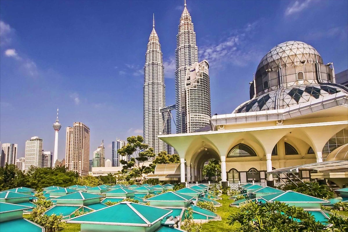 Singapore and Malaysia-Duo Petronas Twin Towers and modern mosque with turquoise umbrellas in Kuala Lumpur skyline