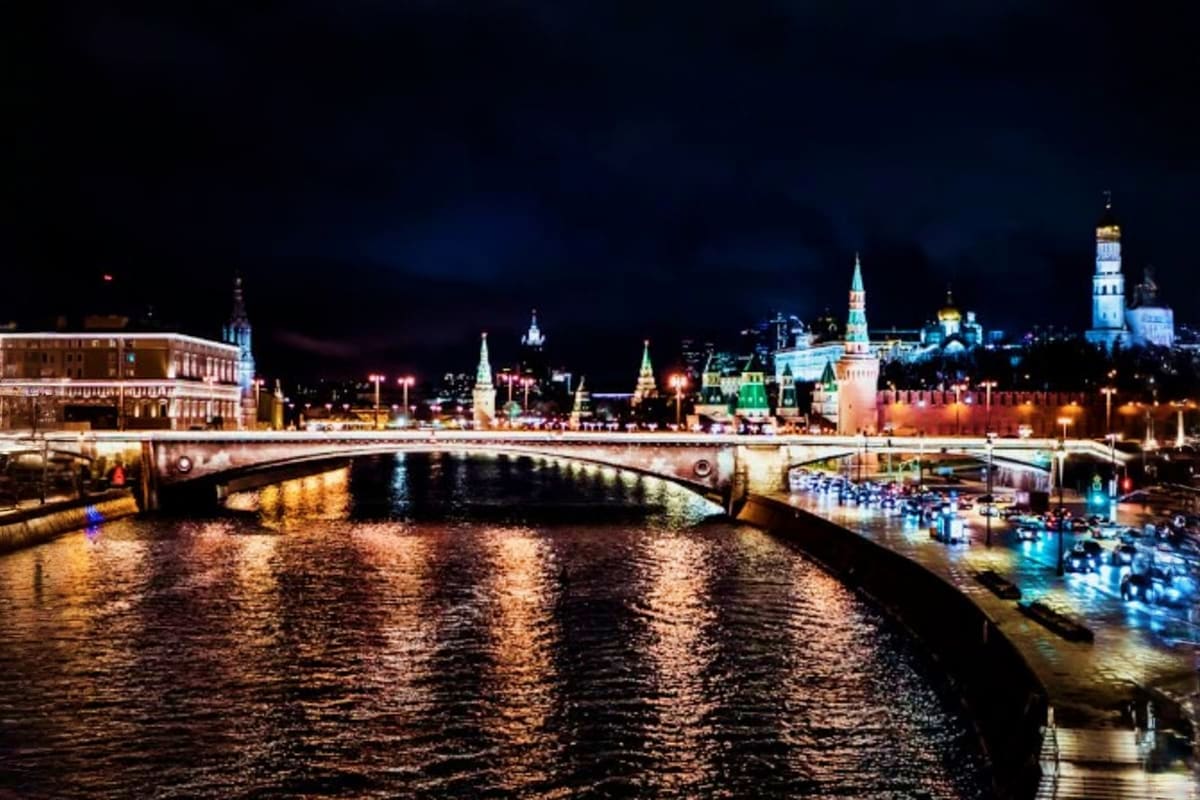 Classic Moscow Family Tour Package Moscow Kremlin and surrounding architecture illuminated at night, with bridge spanning the Moscow River and historic building