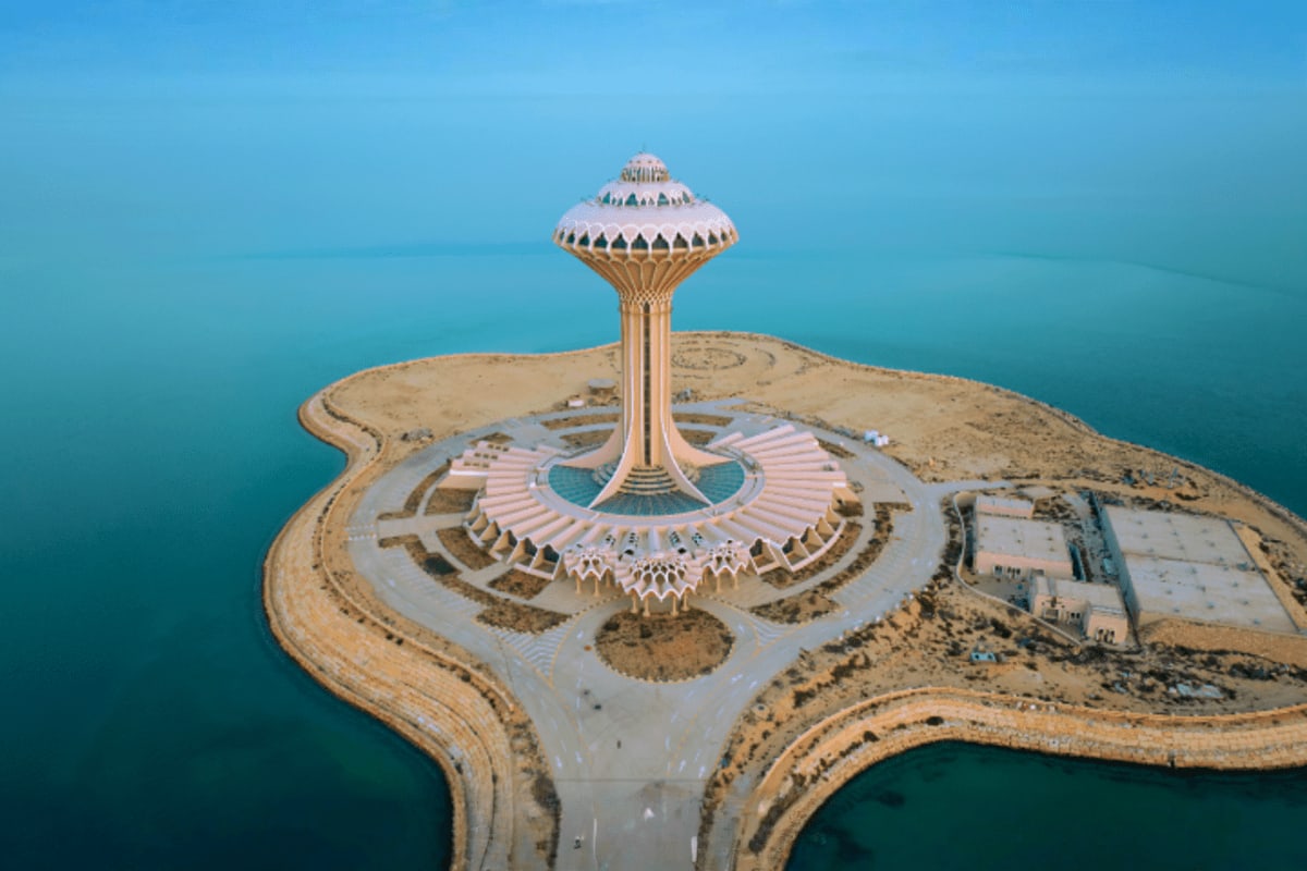 Aerial view of Khobar Corniche Water Tower in Dammam, Saudi Arabia with turquoise gulf waters and curved coastline