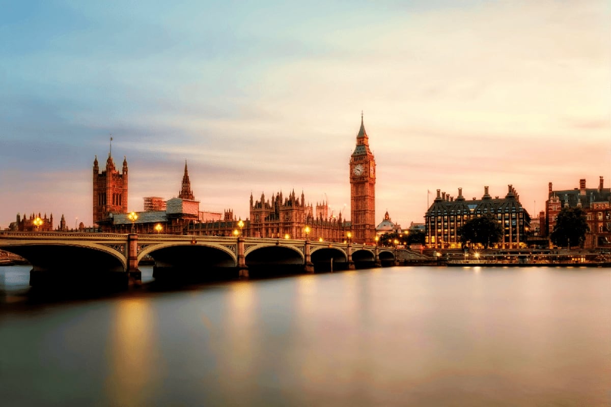 Westminster Bridge and Big Ben illuminated at sunset over the River Thames in London, England