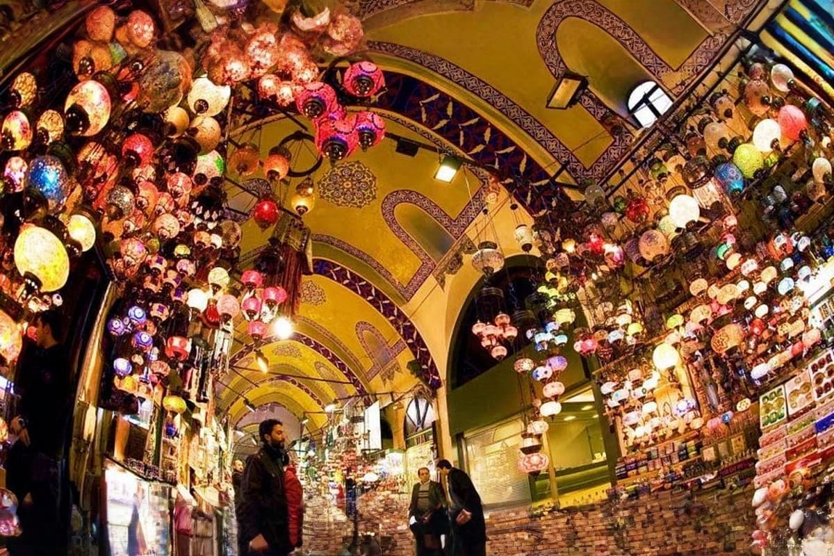 Charismatic Turkey Grand Bazaar lamp section in Istanbul with hundreds of colorful hanging glass lanterns illuminating the ornate yellow ceiling