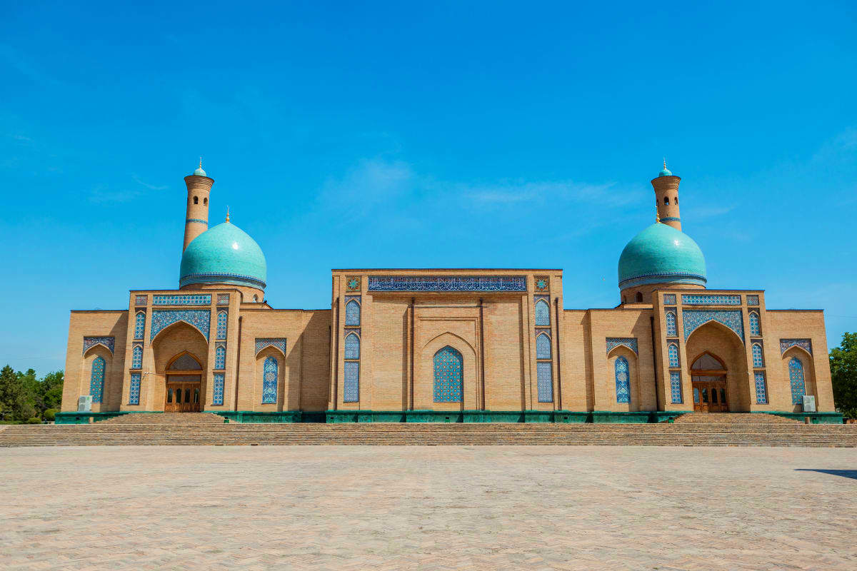 Grand mosque with turquoise domes and twin minarets in Tashkent, Uzbekistan, showcasing traditional Islamic architecture unde
