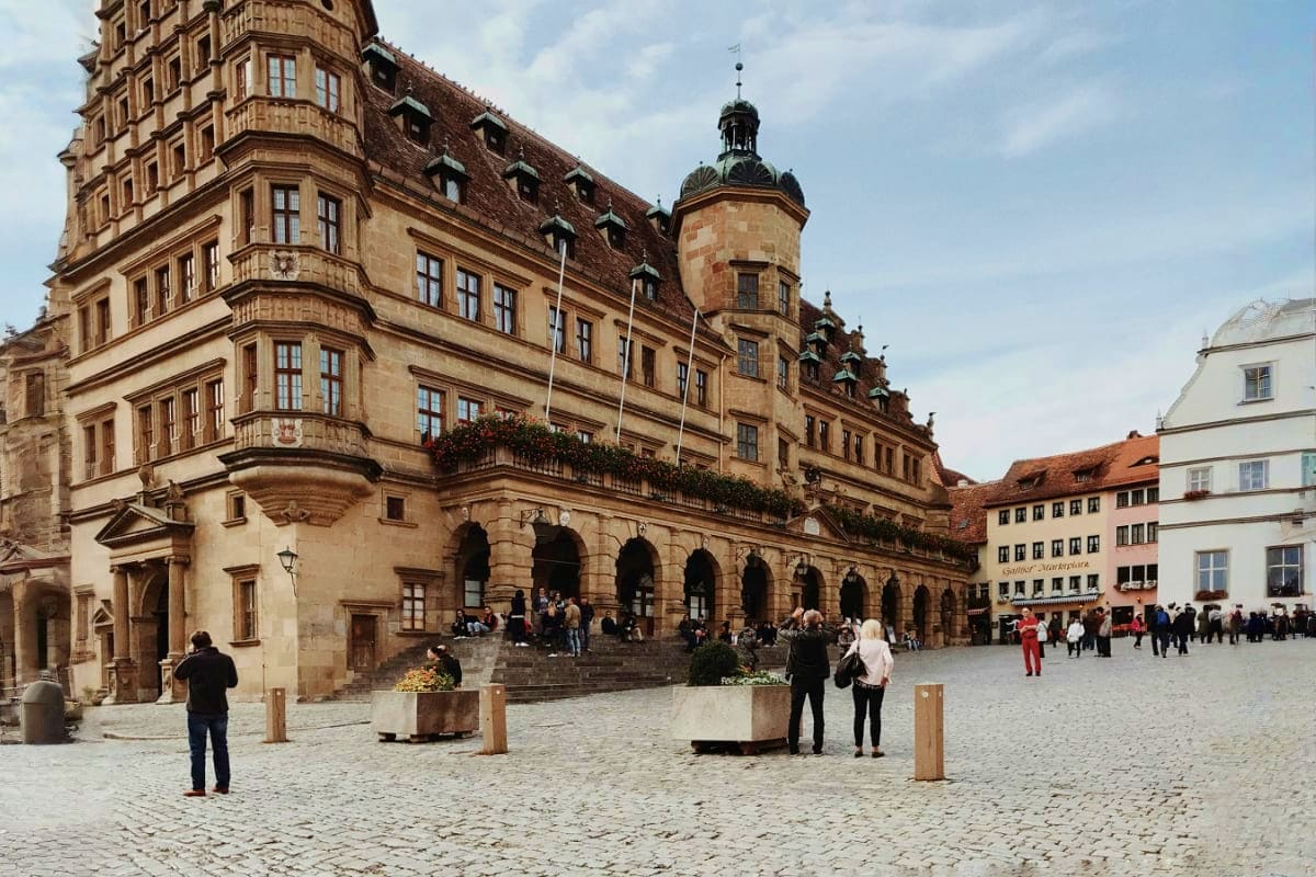 From Prague to Paris Historic town square in Bamberg, Germany with Renaissance architecture, ornate stone buildings with towers, and visitors expl
