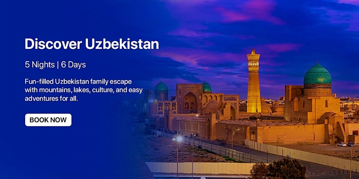 Historic Uzbek architecture at dusk with illuminated minaret and turquoise domed mosque against blue twilight sky