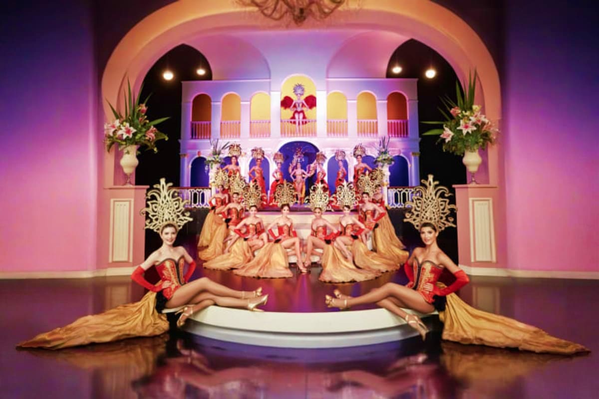 Golden Dome Cabaret Show Elaborate stage set of Golden Dome Cabaret Show with performers in red and gold costumes on multi-level ornate palace backdro