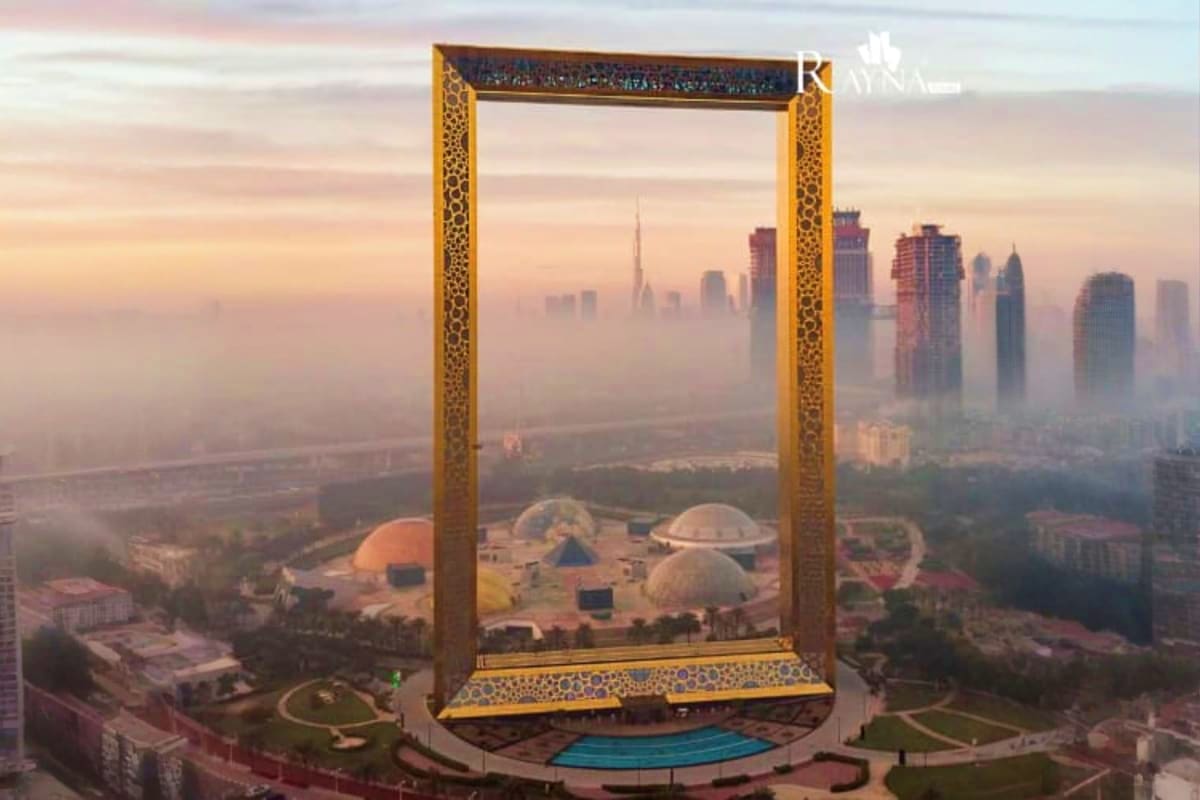 Golden Dubai Frame monument with cityscape skyline view at sunset, featuring modern architecture and landscaped plaza in fore (3)