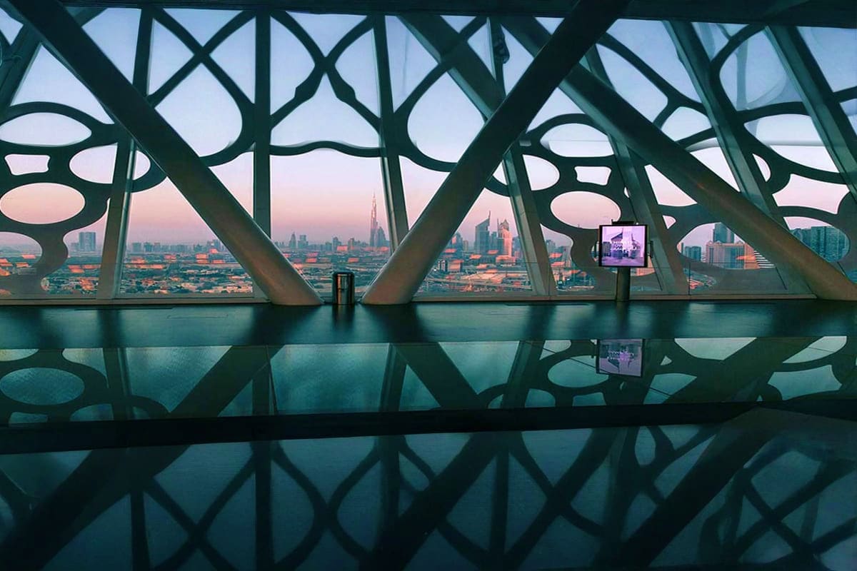 Golden Dubai Frame monument with cityscape skyline view at sunset, featuring modern architecture and landscaped plaza in fore (4)