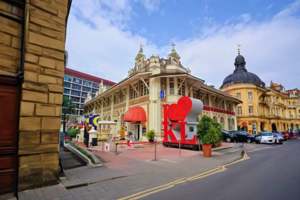 Kuala Lumpur City and Batu Caves Combo Tour Petaling Jaya Gallery building with large red "I Love KL" heart sculpture in Kuala Lumpur city center street