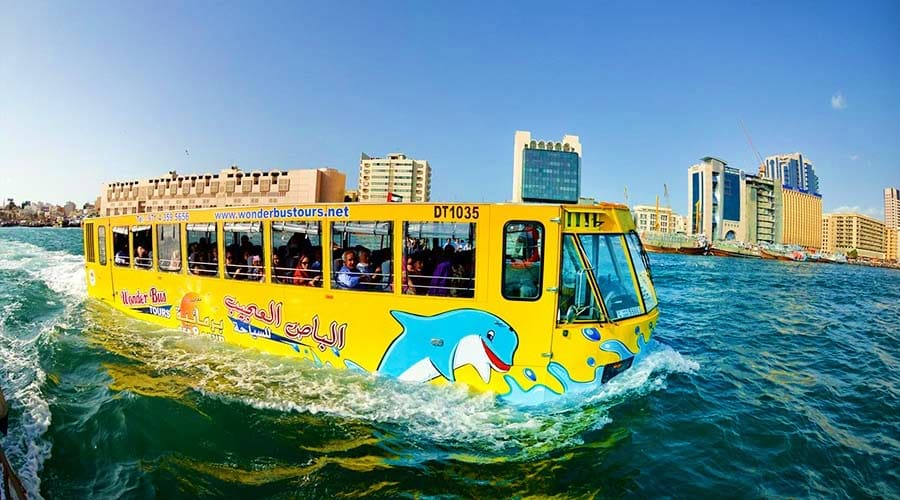 Yellow amphibious Wonder Bus with blue whale design driving into water during Dubai tour (5)