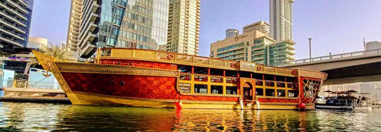 Red and yellow tour boat on water at night with fireworks exploding in sky above city skyline (5)