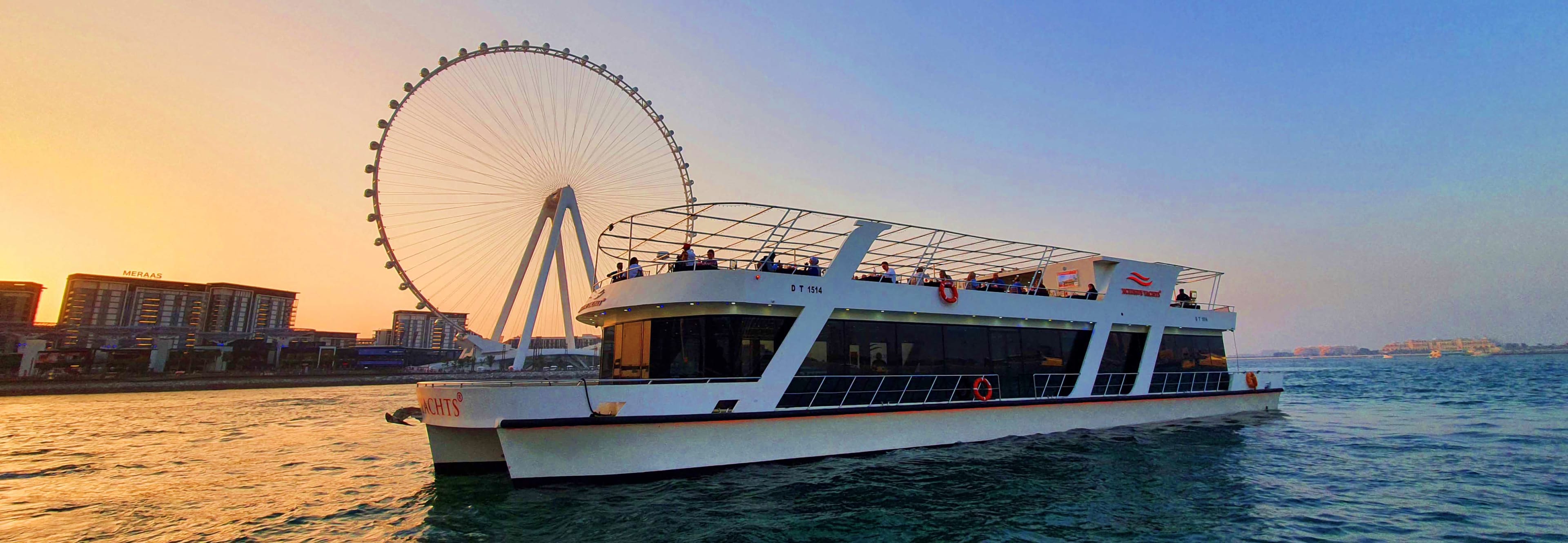 Xclusive Yacht cruise boat on Dubai water with modern skyscrapers and distinctive square tower building in background (2)