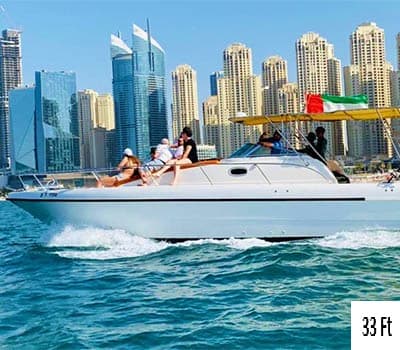 33-foot luxury yacht with passengers on turquoise ocean water, Dubai Marina skyscrapers in background