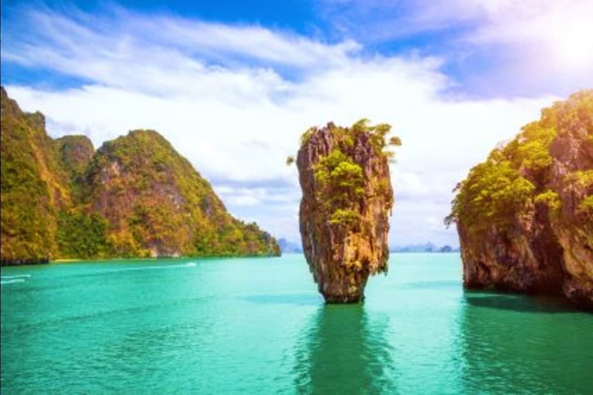Iconic limestone rock formation rising from turquoise waters in Phang Nga Bay, Phuket, Thailand