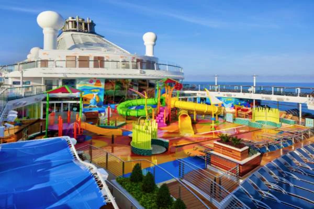 Colorful kids play area and waterslide on Spectrum of the Seas cruise ship deck with ocean view