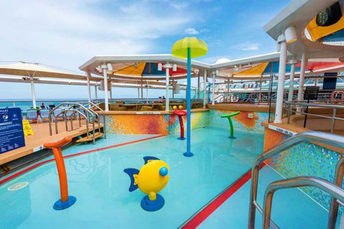 Children's water play area on Cordelia cruise ship with colorful splash pad, interactive water toys, and ocean view
